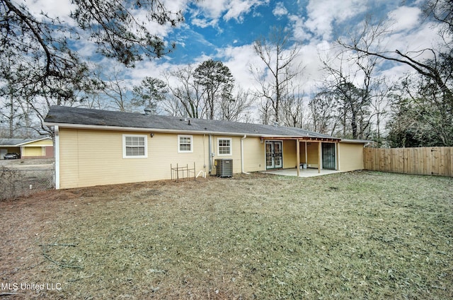 back of house featuring a yard, a patio area, and central air condition unit