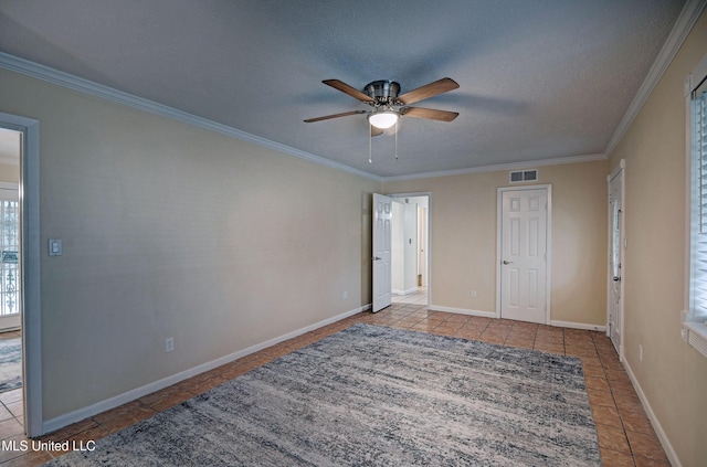 unfurnished bedroom featuring crown molding, ceiling fan, a textured ceiling, and light tile patterned floors