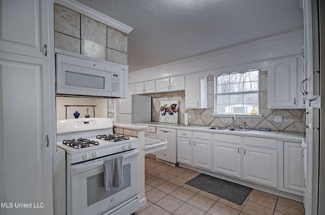 kitchen with sink, white cabinets, and white appliances