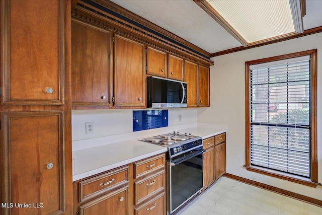634 Twin Harbor Pl, Madison, MS 39110 - kitchen featuring electric range, stainless steel microwave, light floors, light countertops, and brown cabinetry