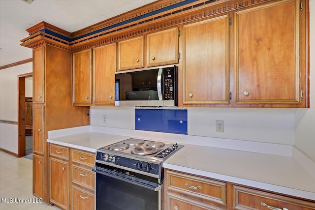 634 Twin Harbor Pl, Madison, MS 39110 - kitchen with electric range, light countertops, brown cabinetry, and crown molding