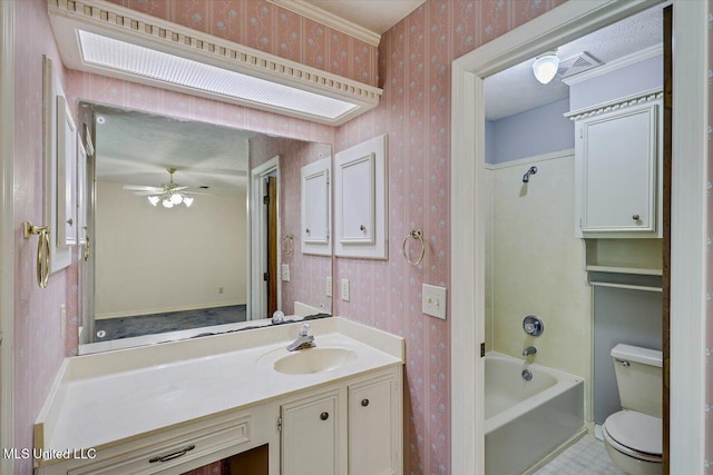 634 Twin Harbor Pl, Madison, MS 39110 - bathroom featuring wallpapered walls, vanity, washtub / shower combination, ceiling fan, and toilet