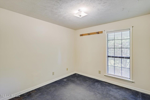 634 Twin Harbor Pl, Madison, MS 39110 - unfurnished room featuring baseboards, dark colored carpet, and a textured ceiling