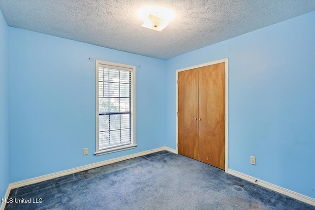634 Twin Harbor Pl, Madison, MS 39110 - unfurnished bedroom with carpet, baseboards, a closet, and a textured ceiling