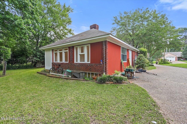 634 Twin Harbor Pl, Madison, MS 39110 - view of property exterior featuring a chimney, brick siding, and a yard