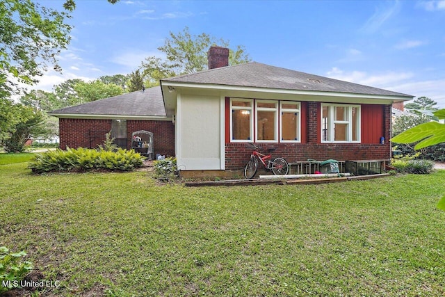 634 Twin Harbor Pl, Madison, MS 39110 - rear view of property featuring a chimney, a yard, brick siding, and a shingled roof