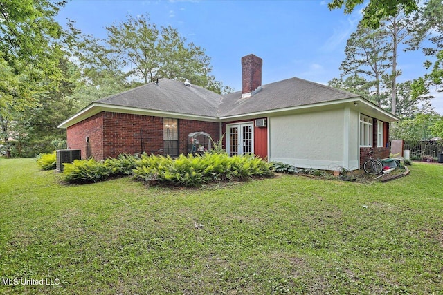 634 Twin Harbor Pl, Madison, MS 39110 - back of property with french doors, cooling unit, a chimney, and a lawn