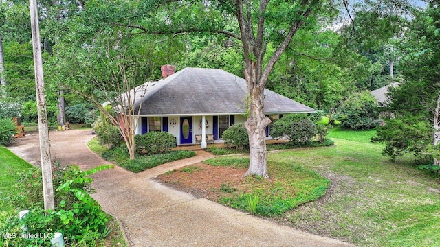 634 Twin Harbor Pl, Madison, MS 39110 - view of front of home featuring driveway, a porch, a chimney, a front yard, and roof with shingles