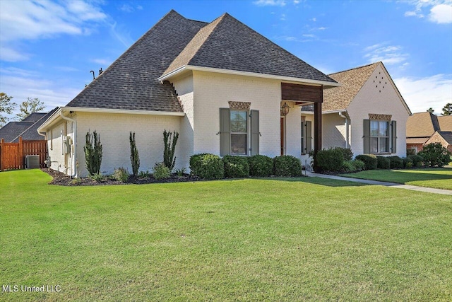 exterior space featuring a front yard and cooling unit