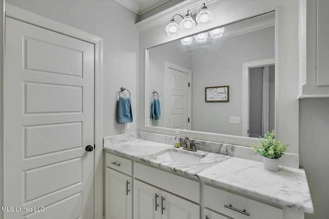 bathroom with ornamental molding and vanity