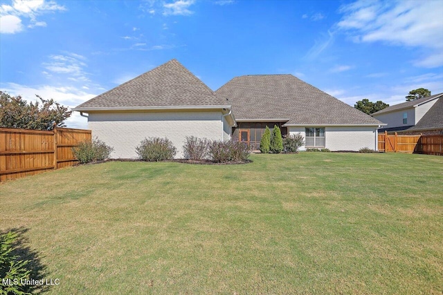 rear view of house with a yard