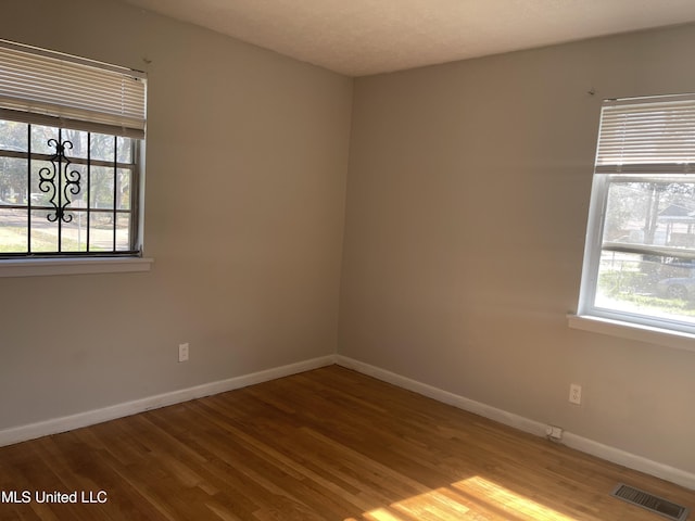 empty room with wood finished floors and baseboards