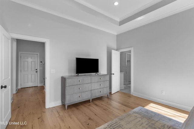 bedroom with light wood-type flooring and crown molding