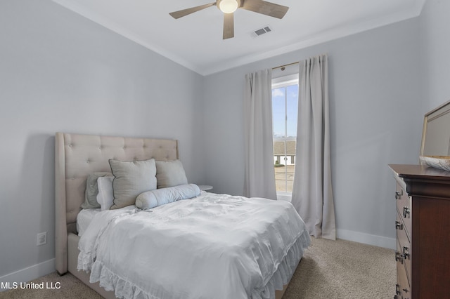 bedroom with light colored carpet, ceiling fan, and crown molding