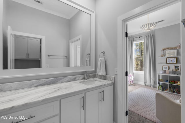 bathroom with vanity and crown molding