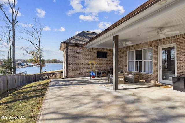 view of patio featuring a water view and ceiling fan