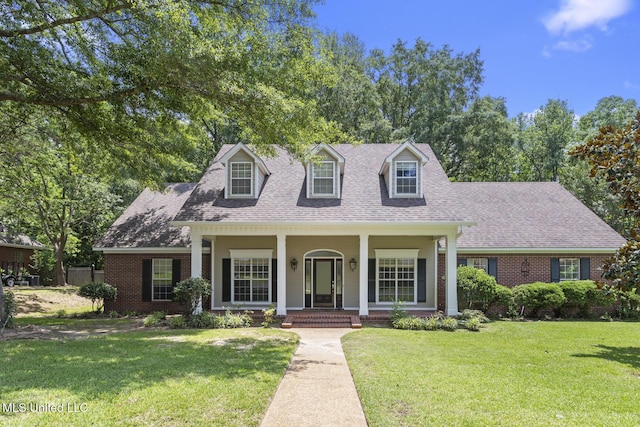 52 Eastgate Dr, Brandon, MS 39042 - cape cod home featuring brick siding, covered porch, roof with shingles, and a front yard