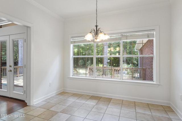 52 Eastgate Dr, Brandon, MS 39042 - unfurnished dining area with plenty of natural light, a chandelier, crown molding, french doors, and light tile patterned floors