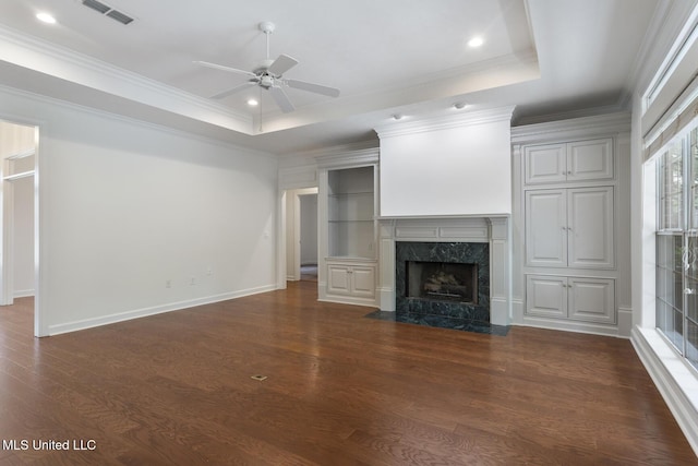 52 Eastgate Dr, Brandon, MS 39042 - unfurnished living room featuring ceiling fan, dark wood finished floors, a raised ceiling, a premium fireplace, and ornamental molding