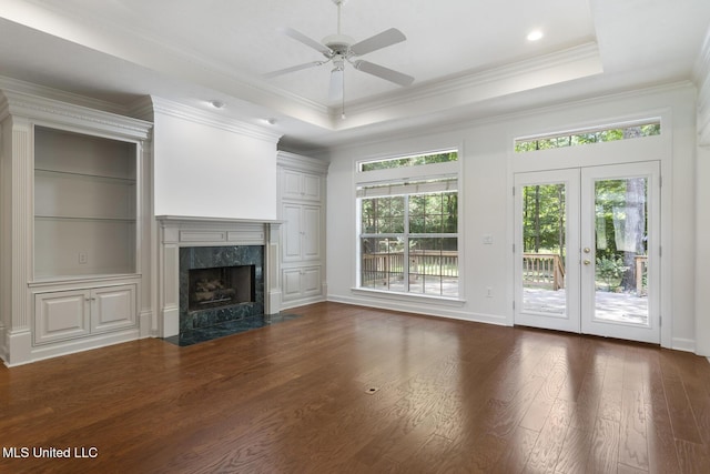 52 Eastgate Dr, Brandon, MS 39042 - unfurnished living room featuring dark wood-style flooring, a high end fireplace, crown molding, a ceiling fan, and a raised ceiling