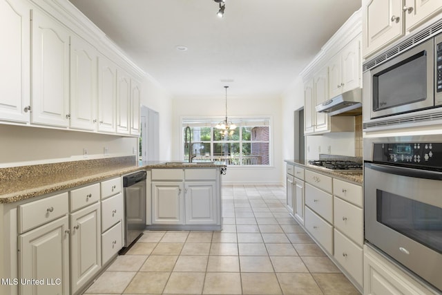52 Eastgate Dr, Brandon, MS 39042 - kitchen with appliances with stainless steel finishes, under cabinet range hood, a chandelier, white cabinets, and light tile patterned floors