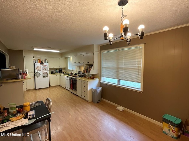 kitchen featuring white appliances, crown molding, pendant lighting, light hardwood / wood-style floors, and white cabinetry