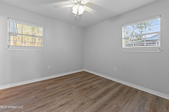 empty room with dark hardwood / wood-style floors and ceiling fan