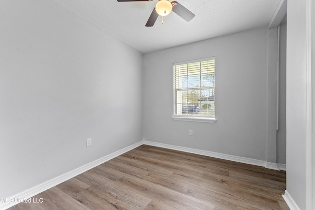 unfurnished room featuring light hardwood / wood-style flooring, a textured ceiling, and ceiling fan