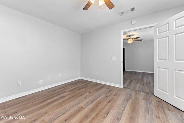 spare room with ceiling fan and hardwood / wood-style flooring