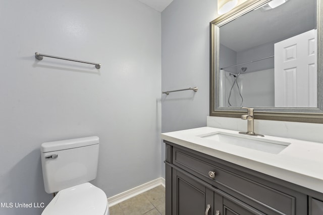 bathroom with vanity, toilet, tile patterned floors, and a shower