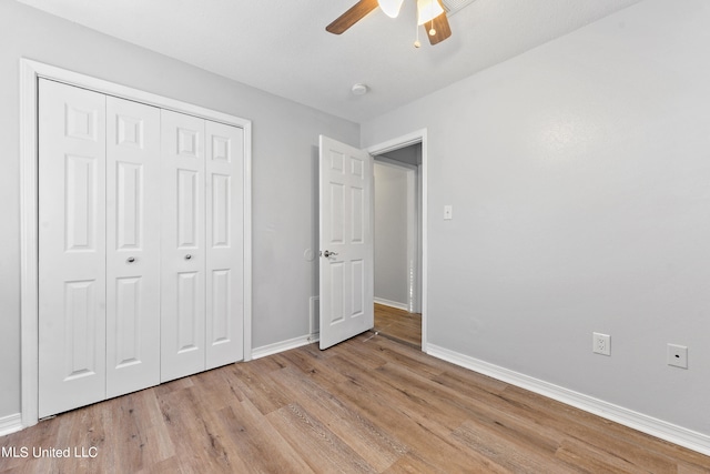 unfurnished bedroom featuring light hardwood / wood-style flooring, a closet, and ceiling fan