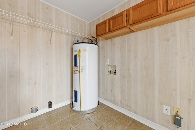 washroom featuring water heater, electric dryer hookup, and wood walls