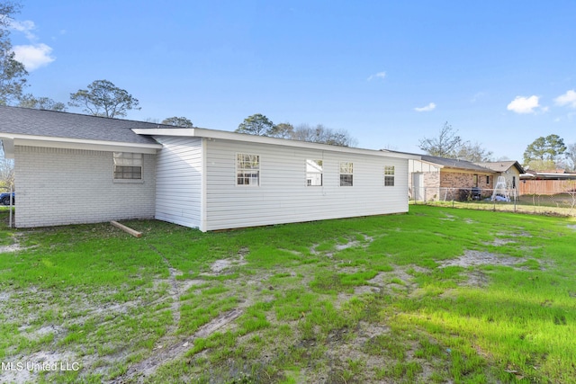 rear view of property with a lawn