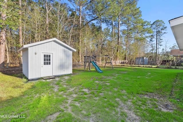 view of yard with a storage shed and a playground