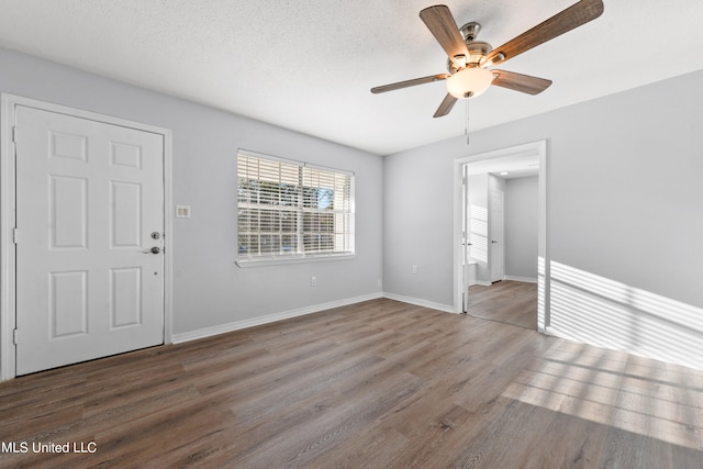 spare room featuring hardwood / wood-style floors, a textured ceiling, and ceiling fan