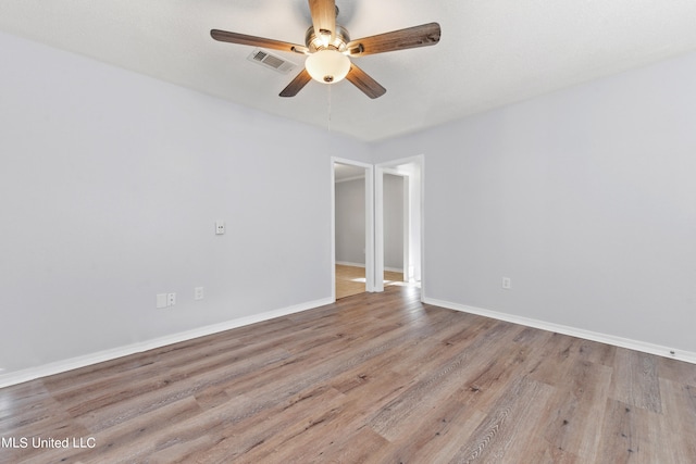 unfurnished room featuring ceiling fan and light hardwood / wood-style flooring