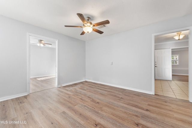 empty room with light wood-type flooring and ceiling fan