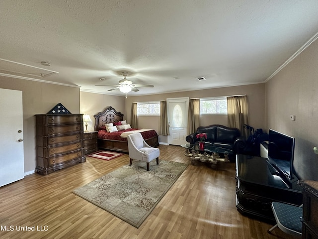 bedroom with ceiling fan, ornamental molding, and hardwood / wood-style flooring