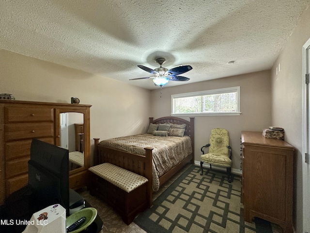 bedroom with a textured ceiling and ceiling fan