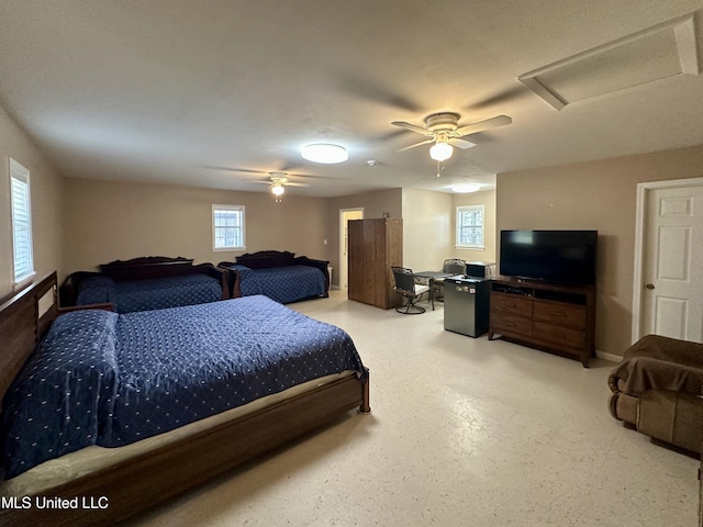 bedroom with ceiling fan and multiple windows