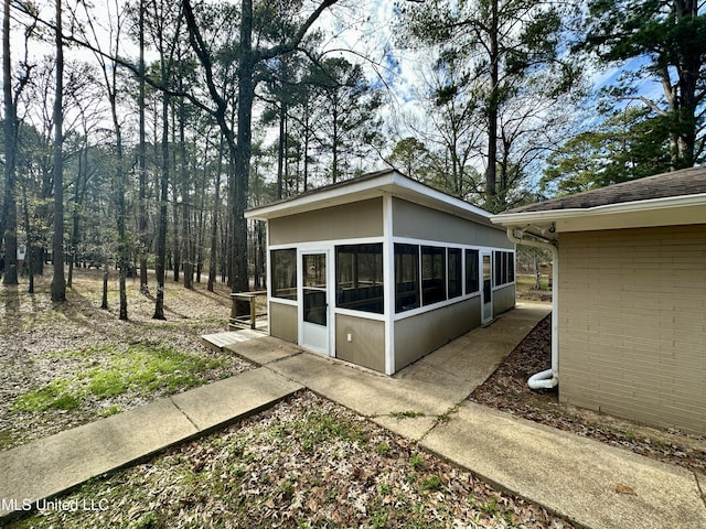 view of side of home featuring a sunroom