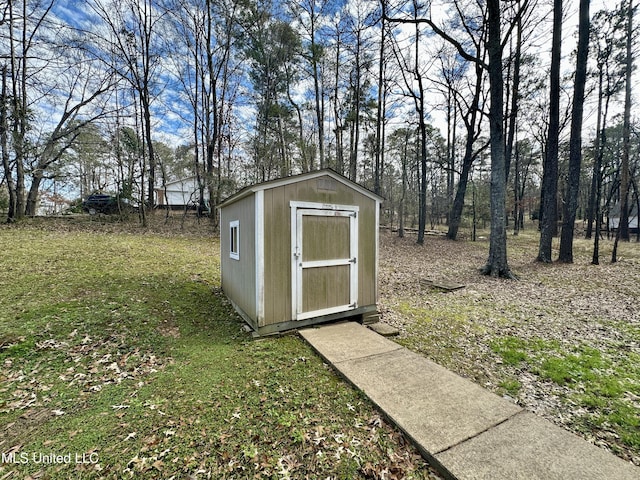 view of outbuilding featuring a lawn