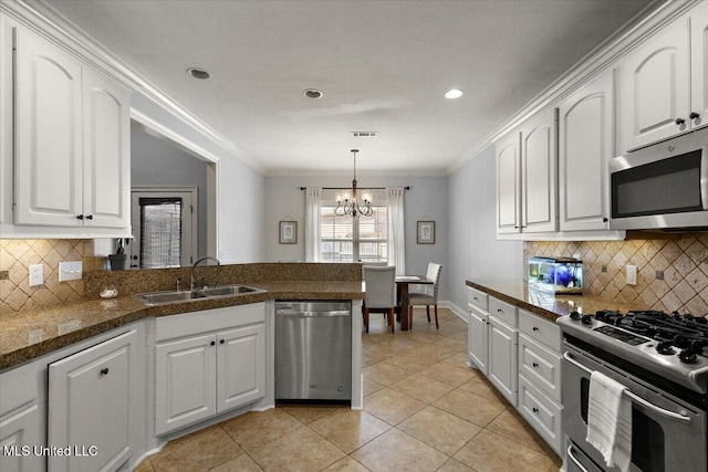 kitchen with a sink, stainless steel appliances, a peninsula, and white cabinets