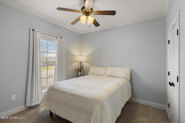 carpeted bedroom featuring a closet, baseboards, ornamental molding, and a ceiling fan