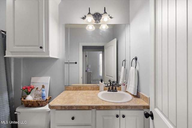 bathroom with toilet and vanity