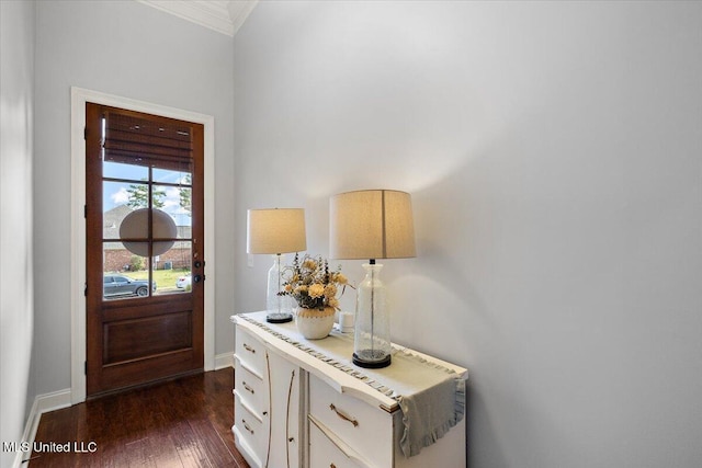 entrance foyer with dark wood-style floors, baseboards, and ornamental molding