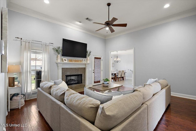 living room featuring visible vents, ceiling fan with notable chandelier, dark wood finished floors, crown molding, and baseboards