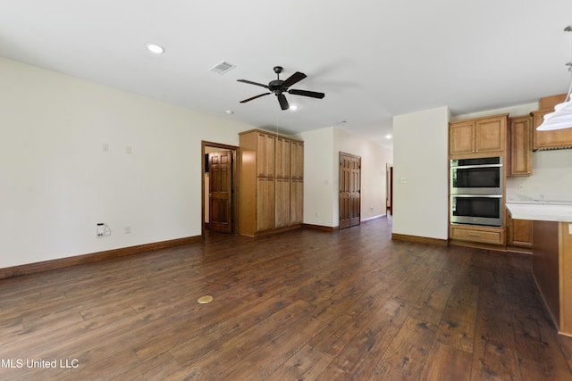 unfurnished living room featuring a ceiling fan, dark wood-type flooring, recessed lighting, and baseboards