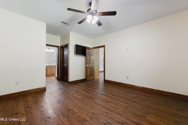 spare room featuring dark wood finished floors, baseboards, and a ceiling fan
