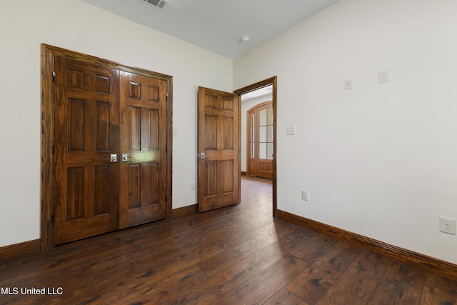 unfurnished bedroom with dark wood-style floors and baseboards